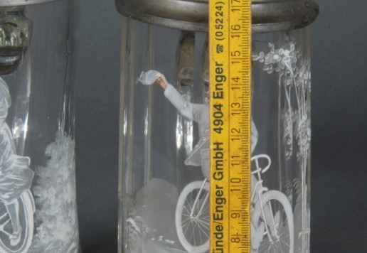 2 decorative glass tankards with bicycle motif  
