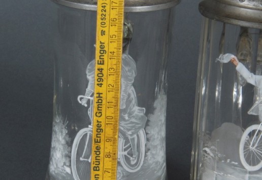 2 decorative glass tankards with bicycle motif  