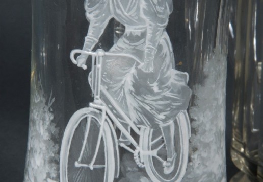 2 decorative glass tankards with bicycle motif  